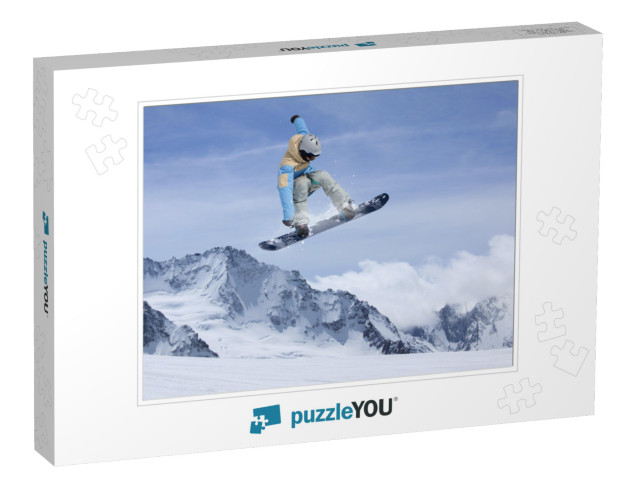 Snowboard rider jumping on mountains. Extreme snow Jigsaw Puzzle