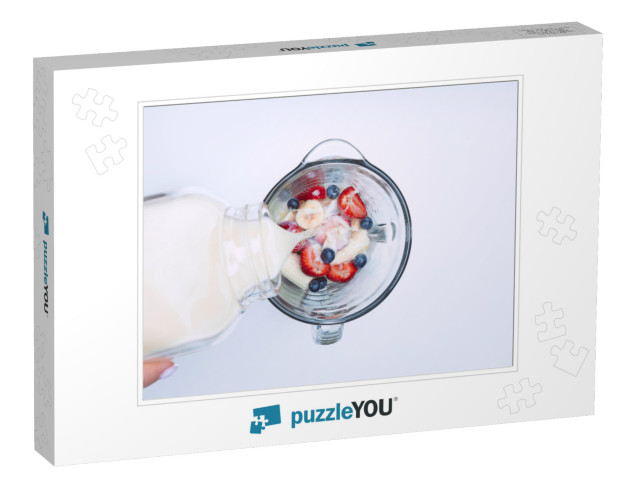 Making smoothie or milkshake in blender. Pouring m Jigsaw Puzzle