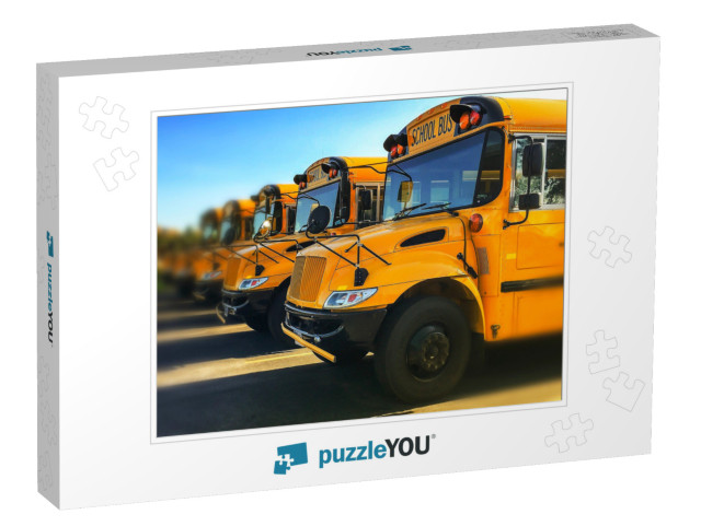 Row of Yellow School Buses Parked Inline with Blurred Bac... Jigsaw Puzzle