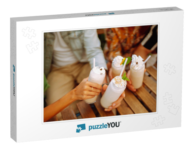 Iced milkshake. Young friends drinking milkshakes Jigsaw Puzzle